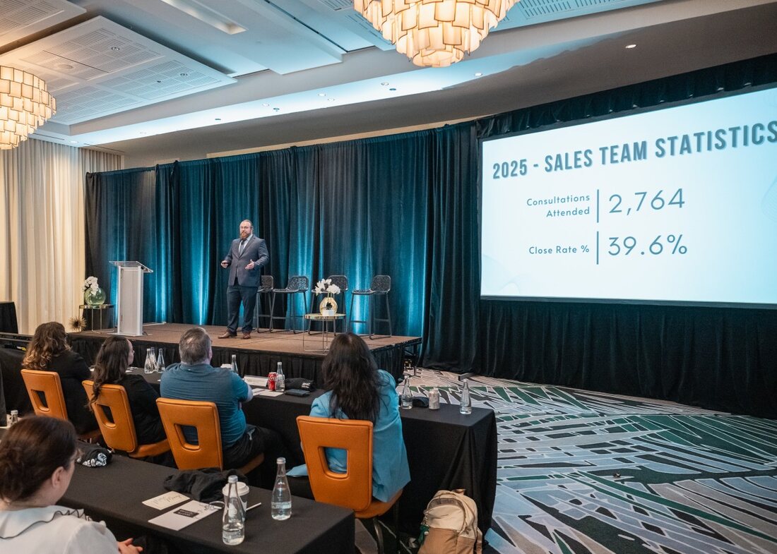 Jesse Holz presenting sales performance figures to an audience